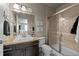 Beautiful bathroom featuring a glass enclosed shower, granite countertop, and modern fixtures at 15230 W Baker Ave, Lakewood, CO 80228