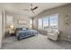 Bright bedroom with large windows, neutral colors, and carpet flooring at 15230 W Baker Ave, Lakewood, CO 80228