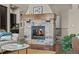Stone fireplace with a wooden mantel and a view of the staircase and living room at 15230 W Baker Ave, Lakewood, CO 80228