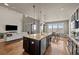 Modern kitchen with a large center island that seamlessly connects the living and dining areas at 15230 W Baker Ave, Lakewood, CO 80228