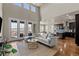 An open-concept living space with access to the balcony and kitchen, offering scenic mountain views at 15230 W Baker Ave, Lakewood, CO 80228