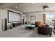 Relax in this expansive living room with a home theater system and cozy furnishings at 15230 W Baker Ave, Lakewood, CO 80228