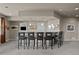 The basement wet bar offers additional seating perfect for hosting social gatherings at 15230 W Baker Ave, Lakewood, CO 80228