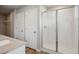 Bathroom featuring a glass enclosed shower and two storage closets at 48295 Shetland Dr, Bennett, CO 80102