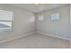 This bedroom features neutral walls, carpet, and two windows showing the outdoors at 48295 Shetland Dr, Bennett, CO 80102