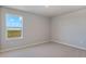 This bedroom features neutral walls, carpet, and a window showcasing the outside at 48295 Shetland Dr, Bennett, CO 80102