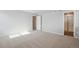 Spacious bedroom with neutral carpet, ample closet space, and an en-suite bathroom entrance at 48295 Shetland Dr, Bennett, CO 80102