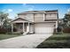 Charming two-story home with a covered front porch and a two-car garage in a suburban neighborhood at 48295 Shetland Dr, Bennett, CO 80102