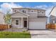 Charming two-story home with a well-manicured lawn and a classic craftsman-style front porch at 48295 Shetland Dr, Bennett, CO 80102