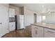 Open-concept kitchen with a stainless steel refrigerator and a center island at 48295 Shetland Dr, Bennett, CO 80102