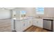 Modern kitchen with white cabinets, an island countertop, and stainless steel appliances at 48295 Shetland Dr, Bennett, CO 80102