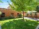 Spacious backyard featuring a stone patio with a dining set, mature trees, and privacy fencing at 562 N Pennsylvania St, Denver, CO 80203