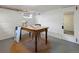 Finished basement area with a wooden table on a jute rug, a painted brick wall and natural light at 562 N Pennsylvania St, Denver, CO 80203