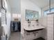 Bathroom featuring double sinks, a walk-in closet, heated towel rack, and classic design at 562 N Pennsylvania St, Denver, CO 80203