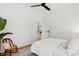 Bright bedroom with white walls, wood floors, and a glimpse into the kitchen through an open door at 562 N Pennsylvania St, Denver, CO 80203