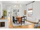 Bright dining room featuring modern lighting, hardwood floors, and built-in display cabinet at 562 N Pennsylvania St, Denver, CO 80203