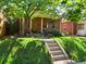 Charming brick home with a welcoming front porch, lush lawn, and mature shade tree at 562 N Pennsylvania St, Denver, CO 80203