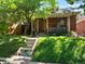 Quaint brick home with a welcoming front porch, lush lawn, and mature shade tree, in a lovely neighborhood at 562 N Pennsylvania St, Denver, CO 80203