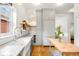 Well-lit kitchen featuring stainless steel appliances, white cabinets, and butcher block island at 562 N Pennsylvania St, Denver, CO 80203