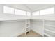 Bright walk-in closet featuring custom shelving and hanging racks with natural light from multiple windows at 562 N Pennsylvania St, Denver, CO 80203