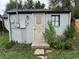 Backyard with grey, one-story shed featuring secure door and a small window for security and natural light at 2429 S Cherokee St, Denver, CO 80223