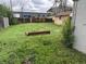 Large backyard features a spacious grassy area, a wooden fence and a small shed at 2429 S Cherokee St, Denver, CO 80223