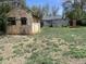 The spacious backyard features a vintage shed and a secure, modern grey shed with a security door at 2429 S Cherokee St, Denver, CO 80223