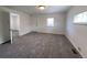 Spacious living room with natural light, carpet floors, and an open layout to adjacent rooms at 2429 S Cherokee St, Denver, CO 80223