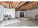 Spacious unfinished basement with exposed ceiling and concrete flooring, ready for your personal design at 5722 S Addison Way # A, Aurora, CO 80016