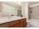 Functional bathroom with traditional cabinetry, vanity, sink and shower-tub combination at 5722 S Addison Way # A, Aurora, CO 80016