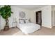 Bright bedroom with carpet and lots of light, features a white bed, plants, and decor at 5722 S Addison Way # A, Aurora, CO 80016