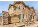 Beautiful multi-story townhouse featuring stone accents, large windows, and a well-manicured yard at 5722 S Addison Way # A, Aurora, CO 80016