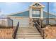 Exterior view of community recreation center with stone accents, blue siding, and wrought iron fencing at 5722 S Addison Way # A, Aurora, CO 80016