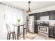 Modern kitchen with stainless steel appliances, ample counter space, and a dining area at 5722 S Addison Way # A, Aurora, CO 80016