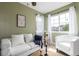 Cozy living room showcases soft green walls, lots of light and modern decor for inviting ambience at 5722 S Addison Way # A, Aurora, CO 80016