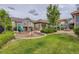 Neighborhood playground with swing, slide, pavilion, and beautiful green grass at 5722 S Addison Way # A, Aurora, CO 80016
