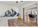 Living room with hardwood floors, mountain art, and a barn door at 300 S Clinton St # 8C, Denver, CO 80247