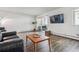 Living room with hardwood floors and sliding door to balcony at 300 S Clinton St # 8C, Denver, CO 80247