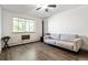 Living room with hardwood floors, a ceiling fan, and a large window at 300 S Clinton St # 8C, Denver, CO 80247