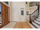 Inviting foyer featuring hardwood floors, a staircase with iron railing and a view to the front door at 9554 E Hidden Hill Ln, Lone Tree, CO 80124