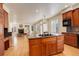 Open kitchen featuring a center island with cooktop and dark countertops, and an open floorplan at 9554 E Hidden Hill Ln, Lone Tree, CO 80124