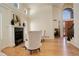 Living room featuring a marble fireplace, hardwood floors, tall ceilings and view of entry at 9554 E Hidden Hill Ln, Lone Tree, CO 80124