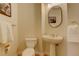 Neutral powder room featuring a pedestal sink and classic fixtures at 9554 E Hidden Hill Ln, Lone Tree, CO 80124