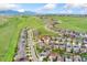 A picturesque aerial view highlighting the location of the home within the community near mountains and green spaces at 19316 W 84Th Pl, Arvada, CO 80007