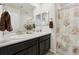 Stylish bathroom featuring a double sink vanity, neutral color scheme, and a shower-tub combination at 19316 W 84Th Pl, Arvada, CO 80007