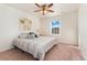 Inviting bedroom with ceiling fan, natural light, and a comfortable bed with stylish bedding at 19316 W 84Th Pl, Arvada, CO 80007
