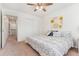 Well-lit bedroom with a ceiling fan, closet, and a neutral color palette for a calming ambiance at 19316 W 84Th Pl, Arvada, CO 80007