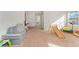 Bright bonus room featuring carpet floors, natural light, and space for play or relaxation at 19316 W 84Th Pl, Arvada, CO 80007