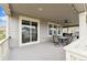 Covered deck featuring outdoor dining set with comfortable seating and large sliding glass doors at 19316 W 84Th Pl, Arvada, CO 80007