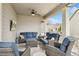 Covered deck featuring comfortable outdoor seating, a ceiling fan, and backyard views at 19316 W 84Th Pl, Arvada, CO 80007